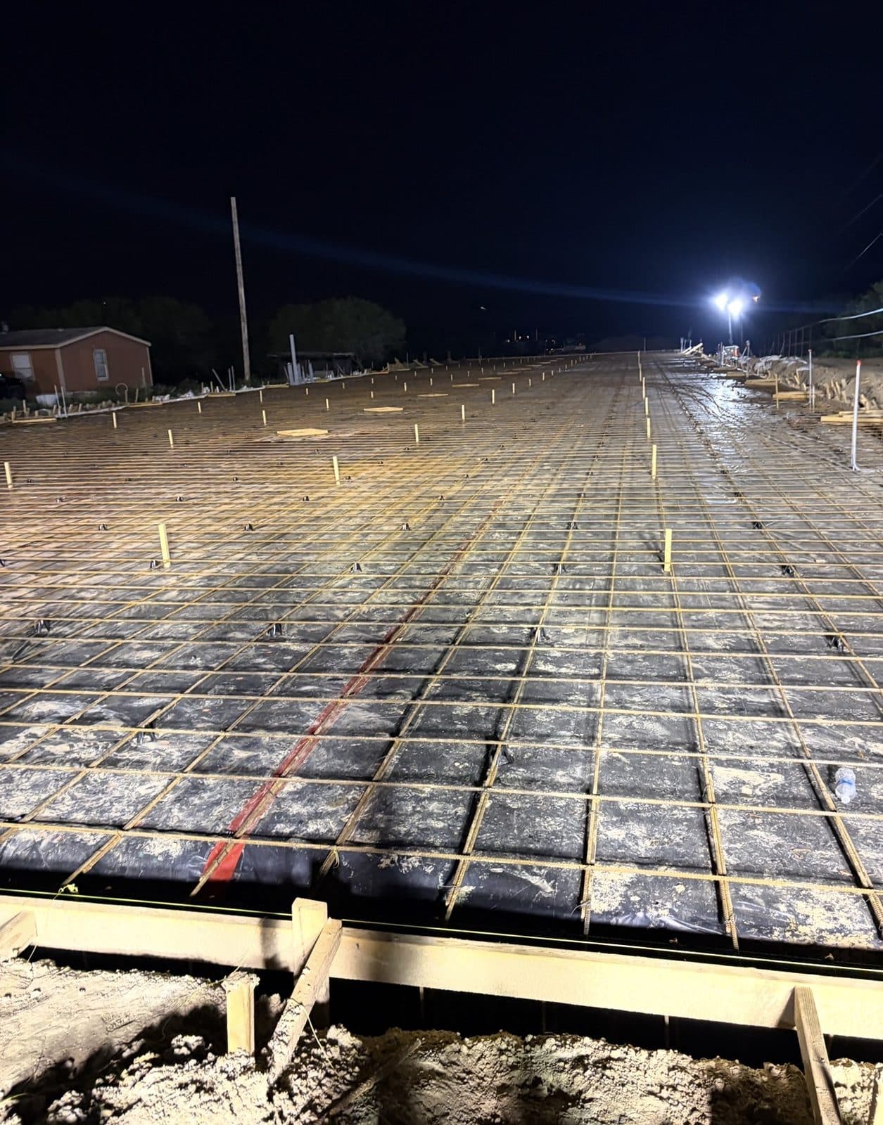2J Concrete Services crew completing a concrete pour at night